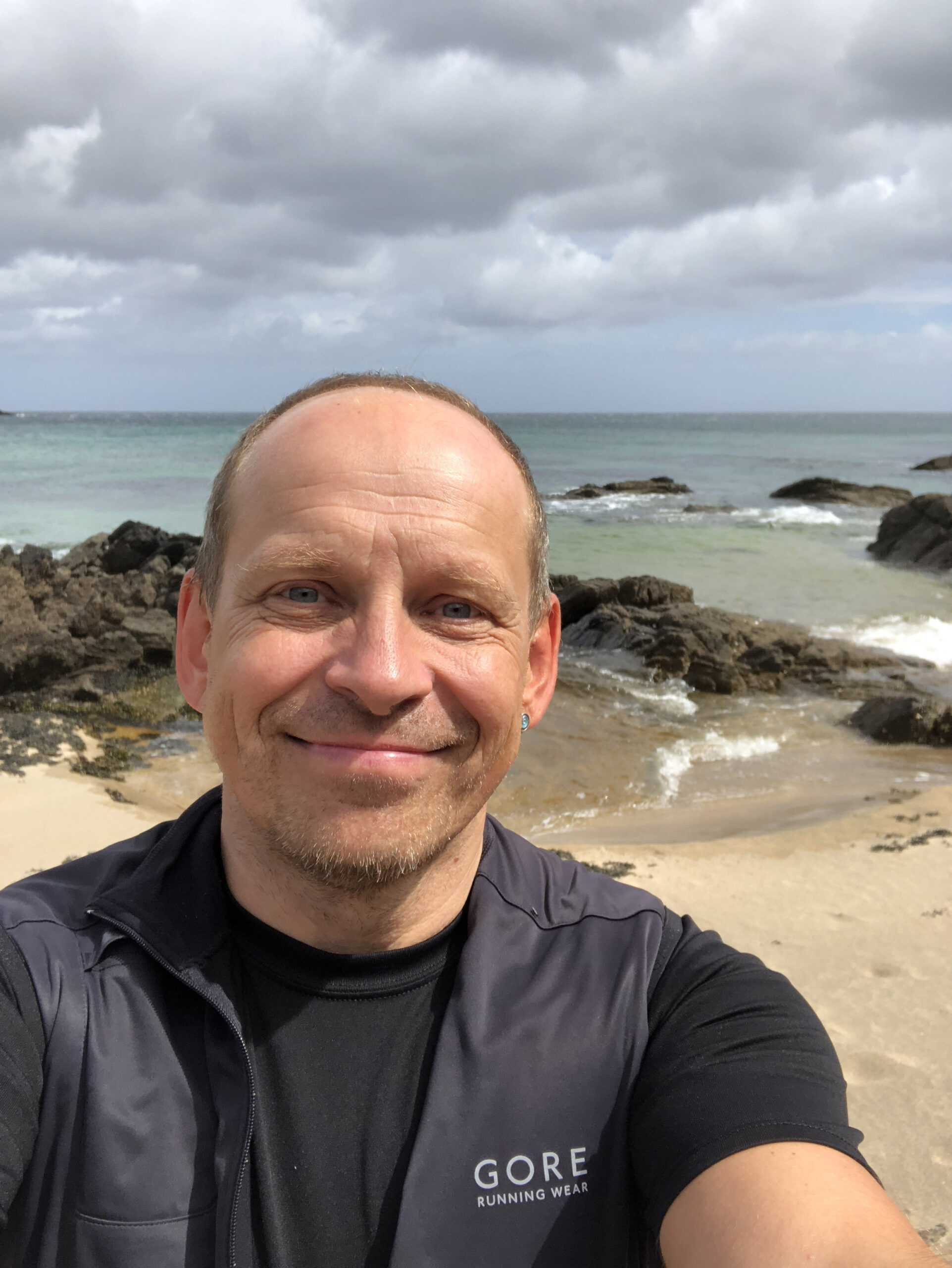 Strahlender Tom Oberbichler mit Meer im Hintergrund - Regeneration